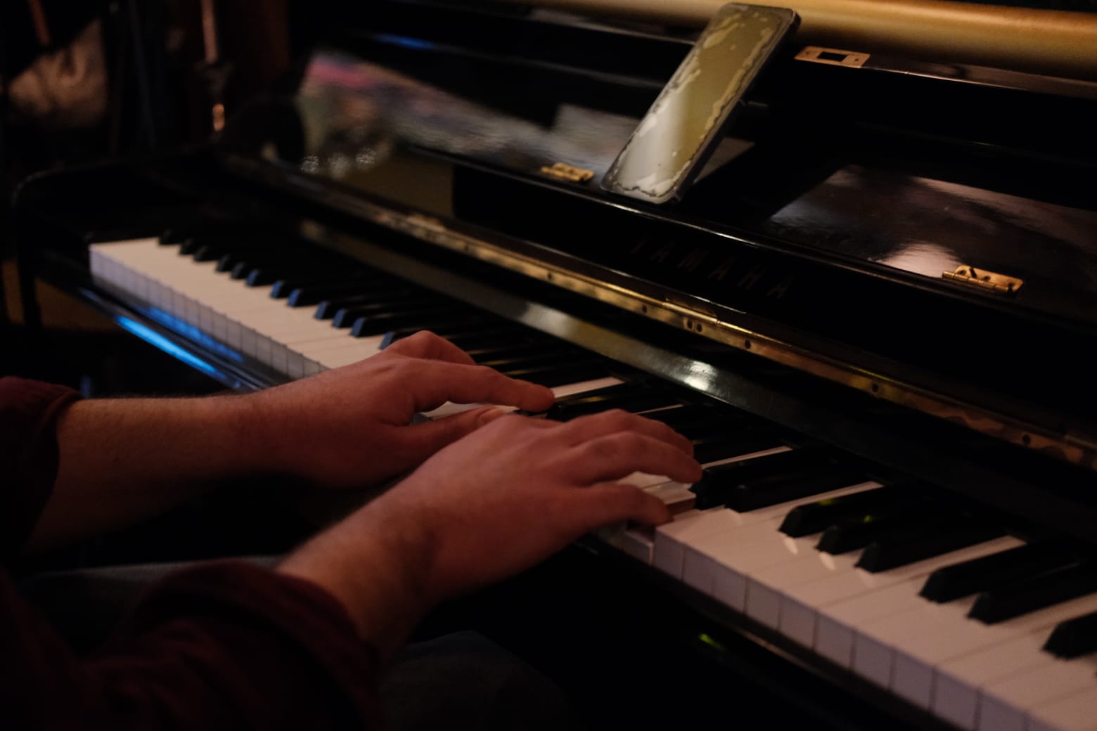 Close up of hands playing piano keys